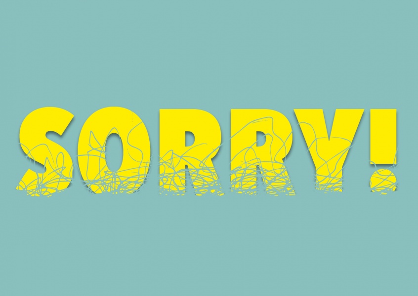 Yellow Sorry in captial letters on mint colored background