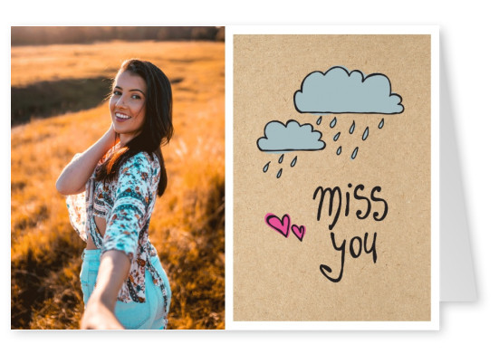 I miss you handwritten on cardboard with rainy clouds–mypostcard