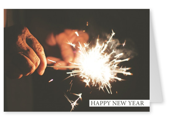 New years card with photo of a burning sparkler in the dark