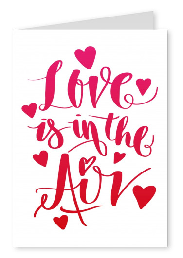 Love is in the air in red handwriting with heart