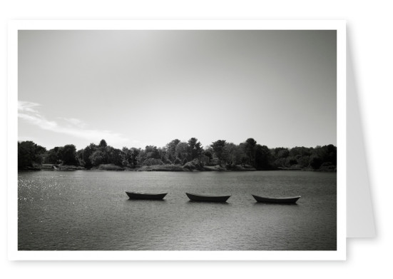 black n white photo of 3 boats on a river