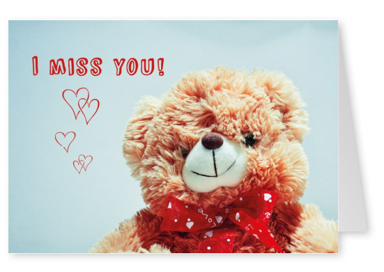 Flauschiger Stoff-Teddy mit roter Schleife, illustrierten Herzen und dem Spruch I miss you