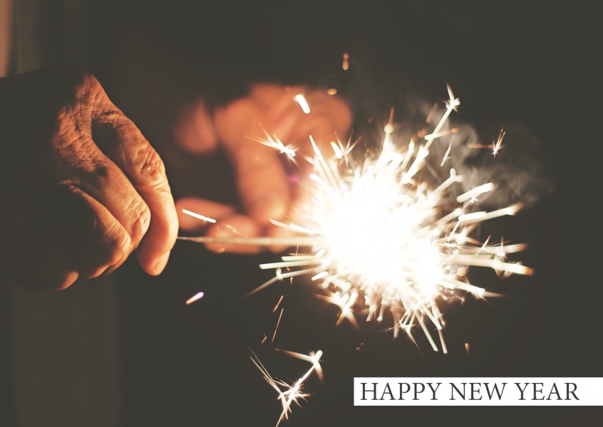 New years card with photo of a burning sparkler in the dark