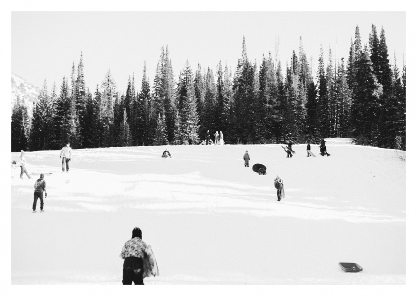 Kids with their sledges on snowy hill