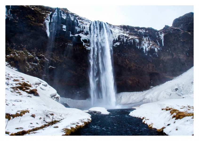Huge waterfall in winter landscape