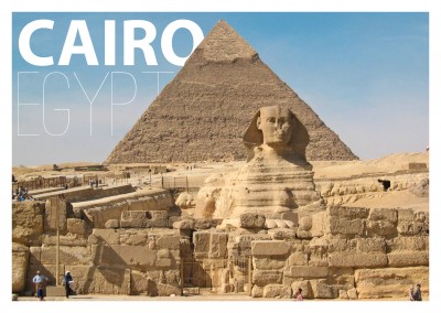 Photo of sphinx statue with pyramid in the background