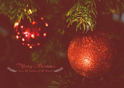 Frohe Weihnachten mit rote Christbaumkugeln