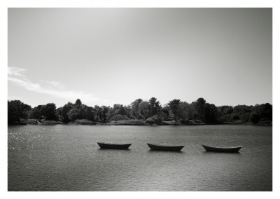 black n white photo of 3 boats on a river