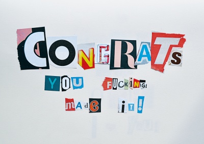 colourful newspaper snippets that make up the message congrats you f*cking made it